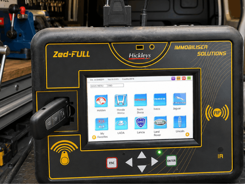 Transponder chip inside a car key fob being programmed by an auto locksmith in Essex