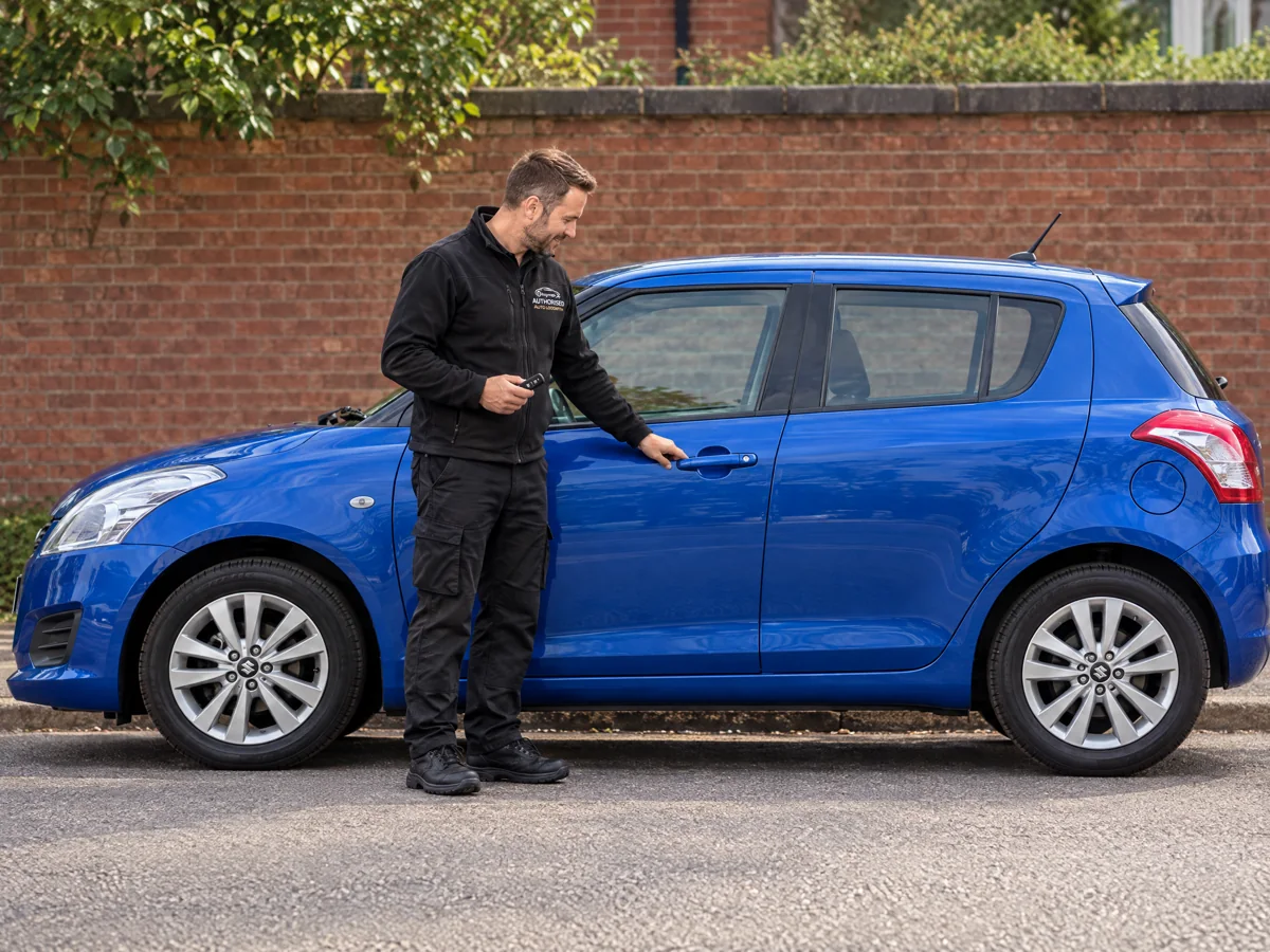 Auto locksmith checking the door lock on a Suzuki in Essex